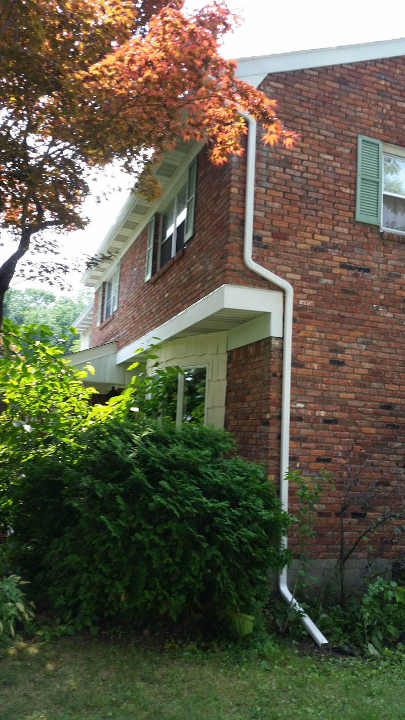 2nd Floor downspout on brick